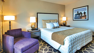 A deluxe room with a king size bed at Zia Park Casino, Hotel and Racetrack..