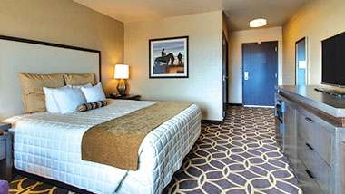 A deluxe room with a king size bed at Zia Park Casino, Hotel and Racetrack..