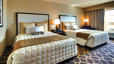 A deluxe room with two queen size beds at Zia Park Casino, Hotel and Racetrack..