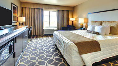 A deluxe room with a king size bed at Zia Park Casino, Hotel and Racetrack..