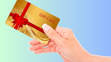 A hand holding a gift card