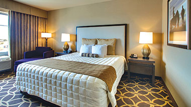 A deluxe room with a king size bed at Zia Park Casino, Hotel and Racetrack..