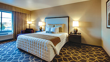 An extended room with a king size bed at Zia Park Casino, Hotel and Racetrack.